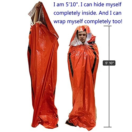 Person inside an orange emergency survival sleeping bag, demonstrating its size.