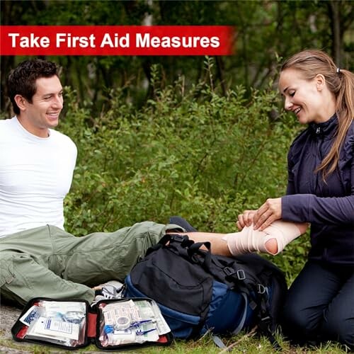 Two people outdoors using a first aid kit.